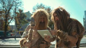 Two cavemen looking at a laptop Neurosis